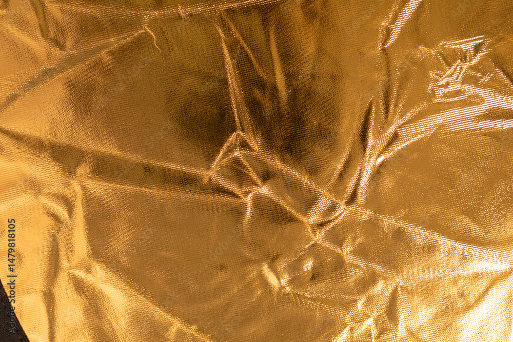 Poster close-up of a crumpled gold fabric with a metallic sheen. perfect for luxurious backgrounds.