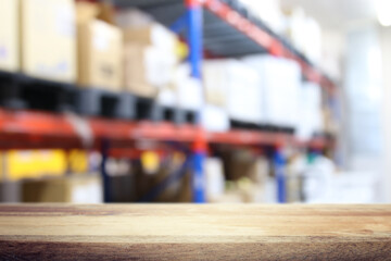 Empty table and industry warehouse background with bright lights