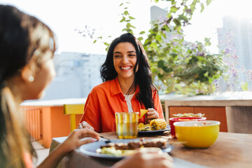 Mother and daughter enjoying a joyful meal together outdoors