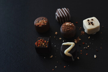 Luxury chocolate assortment on a dark tray
