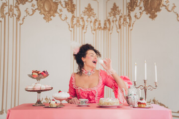 Young woman enjoying a luxurious tea party in a vintage setting