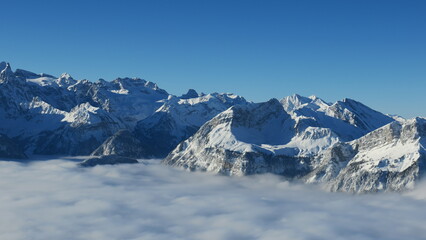 Stunning winter landscape photo of snow-covered mountains peaking above a sea of clouds. Perfect for travel, nature, or winter backgrounds.