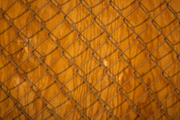 Fototapeta premium Rustic chain link fence texture on weathered wood. Perfect for backgrounds or design elements.