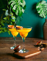 Fresh passion fruit maracuja alcoholic cocktail with ice cubes