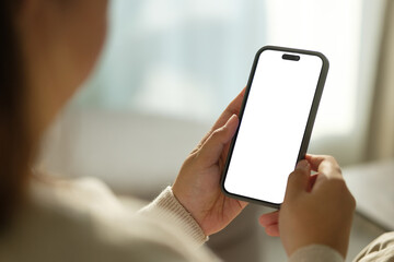 Close up of woman holding smartphone with blank screen, for mobile app mockups or digital content