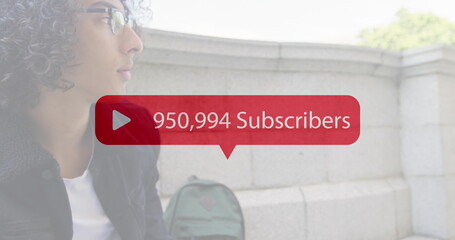 Increasing subscribers on red speech bubble against mid section of a man using smartphone