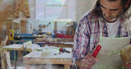 Image of data processing over caucasian male carpenter working in workshop