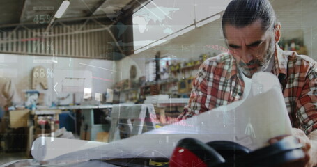 Image of world map and data processing over caucasian male carpenter working in workshop