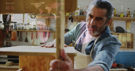 Image of world map and data processing over caucasian male carpenter working in workshop