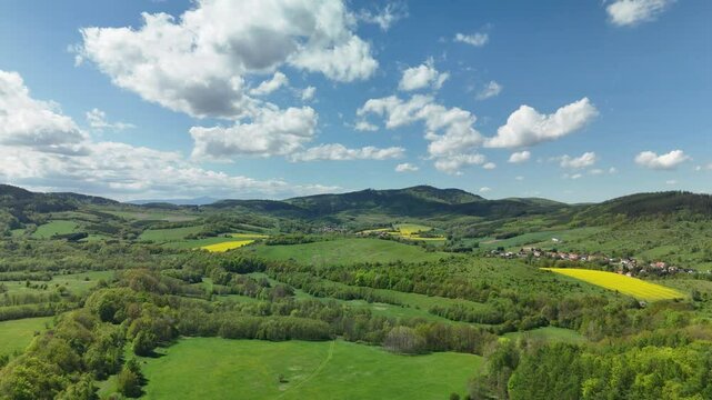 Aerial View of Rolling Hills, Forest and Countryside Fields in Lower Silesia, Poland on a Sunny Spring Day
