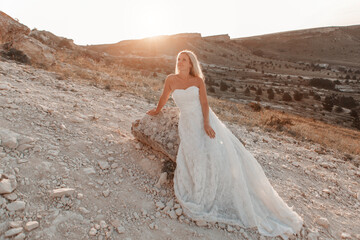 a woman in a white dress, a bride on a mountain with a blue sky. Beautiful nature, freedom, enjoyment of life. High quality photo