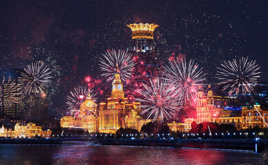 Golden retro clock tower and urban office buildings with Imperial crown of Westin Bund Center with fireworks - Shanghai, China