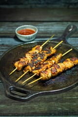 Chicken satay is grilled, marinated chicken skewers served with a rich, savory peanut sauce, popular in Southeast Asian cuisine.
