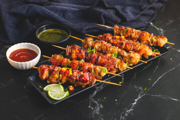 Chicken satay is grilled, marinated chicken skewers served with a rich, savory peanut sauce, popular in Southeast Asian cuisine.
