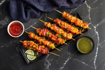 Chicken satay is grilled, marinated chicken skewers served with a rich, savory peanut sauce, popular in Southeast Asian cuisine.
