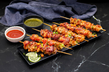 Chicken satay is grilled, marinated chicken skewers served with a rich, savory peanut sauce, popular in Southeast Asian cuisine.
