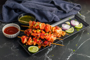 Chicken satay is grilled, marinated chicken skewers served with a rich, savory peanut sauce, popular in Southeast Asian cuisine.

