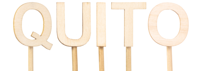 Name of Quito, capital of Ecuador, in large light wood letters on white background. Latin American city