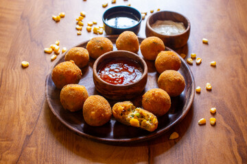 Corn cheese balls are crispy, golden-fried snacks made with corn, cheese, and spices, offering a cheesy, savory, and crunchy bite.
