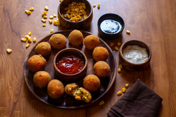 Corn cheese balls are crispy, golden-fried snacks made with corn, cheese, and spices, offering a cheesy, savory, and crunchy bite.
