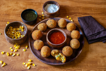 Corn cheese balls are crispy, golden-fried snacks made with corn, cheese, and spices, offering a cheesy, savory, and crunchy bite.
