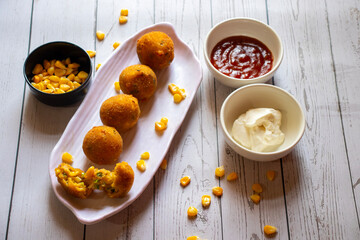 Corn cheese balls are crispy, golden-fried snacks made with corn, cheese, and spices, offering a cheesy, savory, and crunchy bite.
