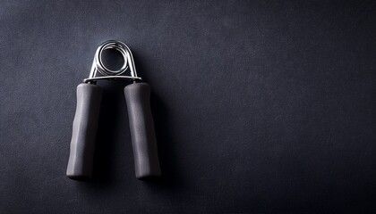 hand gripper on a dark surface for strength training