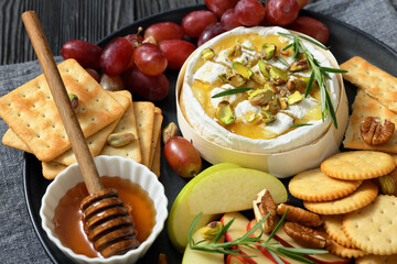 Baked Camembert with honey, pistachios, top view