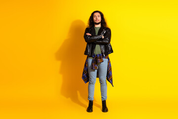 Confident Young Man Poses Against Vibrant Yellow Background Expressing Urban Fashion Style and Hip Streetwear Trends