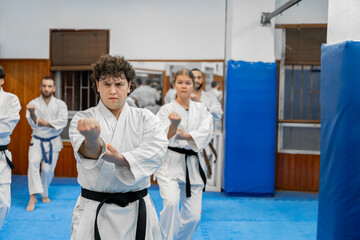 Karate students training together in dojo: practicing martial arts