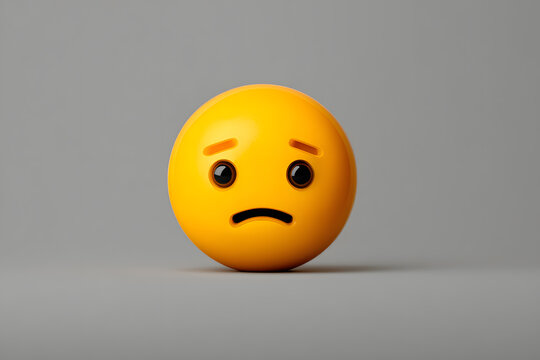 Bright yellow sad emoji with a frown and raised eyebrows against a gray background conveying a sense of disappointment or sadness - Powered by Adobe