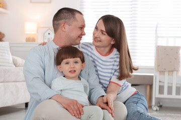 Obraz premium Cute little boy and his parents at home. Lovely family