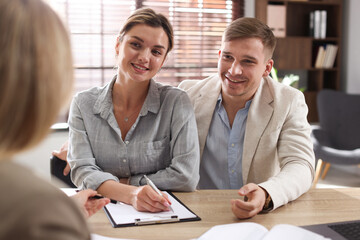 Couple having meeting with banker at desk in office