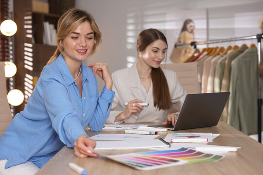 Fashion stylists working at table in studio