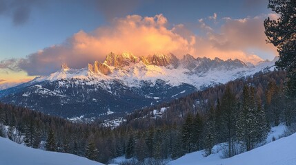 Obraz premium Winter sunrise over snow-capped mountain peaks.