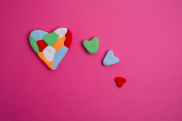 Obraz premium Autism awareness day, world autism day. Colored heart on color background 