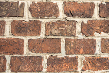 Brown brick wall background with rough bricks texture and aged mortar joints with copy space suitable for design project