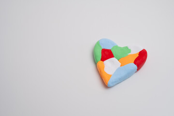 Autism awareness day, world autism day. Colored heart on color background
