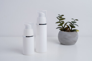 Container for cream, shampoo, toiletries, spa. Unbranded white plastic bottles. Bottle with a dispenser for cosmetic products. Skin care and beauty concept. Mockup style, copy space  
