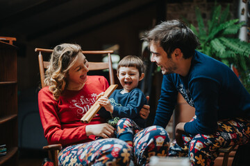 A family spending quality time together in joyful festive spirits, dressed comfortably at home. The...