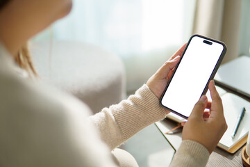 Close up os woman hands holding mobile phone with white empty screen.