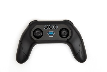 Modern black game controller with joysticks and buttons on white background, top view of a sleek wireless gaming accessory.