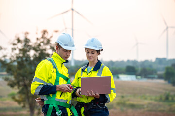 Technician and Engineer Working on a Windmill Turbine in the Field, Harnessing Renewable Energy for Sustainable Power Generation, Using Advanced Technology and Innovation to Support the Environmental