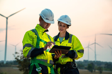Technician and Engineer Working on a Windmill Turbine in the Field, Harnessing Renewable Energy for Sustainable Power Generation, Using Advanced Technology and Innovation to Support the Environmental