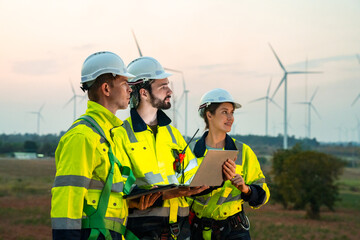 Technician and Engineer Working on a Windmill Turbine in the Field, Harnessing Renewable Energy for...
