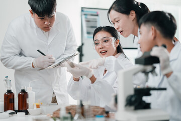 Researchers presenting scientific findings in a laboratory meeting, discussing experimental...