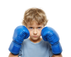 Young boy with blonde hair is wearing blue boxing gloves, displaying serious expression. He is ready for action, showcasing determination and focus. background is isolated, emphasizing subject