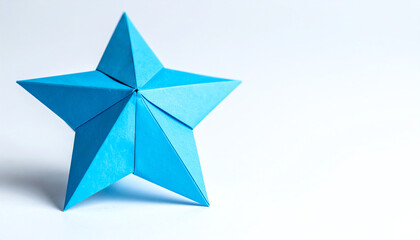 A vibrant blue origami star against a clean white background, showcasing a geometric design and artistic craftsmanship