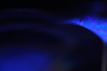 Deep purple liquid surface on black background, oil stains movement, bright chemistry, surreal background