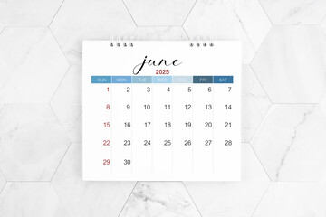 June 2025 blank desk calendar on marble table, Flat lay.